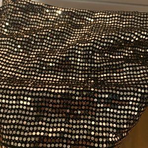 Cropped sparkly black and gold tank top.